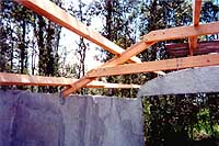 [detail - truss bolting and metal bracket connecting truss to wall]