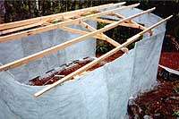 [rear quarter view of partially completed roof framing]