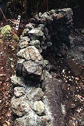 [End view of rock wall under construction]